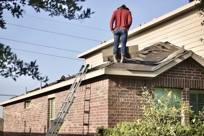 Professional roofer working on a residential roof in McAllen